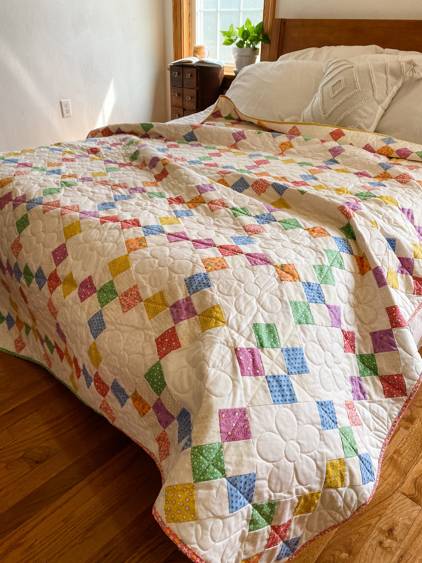 A colorful, traditional 9-patch block but it is set on-point to make it a bit more gorgeous to look at. This quilt is a twin size 66"x 88" pictured on a queen bed. The drape off the sides/bottom will be about 8" off each side. 