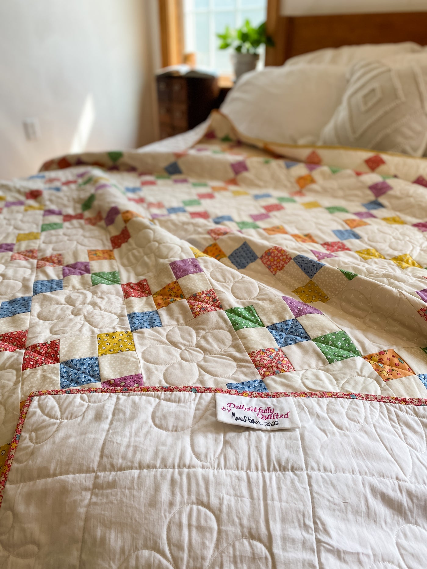 A colorful, traditional 9-patch block but it is set on-point to make it a bit more gorgeous to look at. This quilt is a twin size 66"x 88" pictured on a queen bed. The drape off the sides/bottom will be about 8" off each side with a white backing.