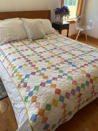 A colorful, traditional 9-patch block but it is set on-point to make it a bit more gorgeous to look at. This quilt is a twin size 66"x 88" pictured on a queen bed. The drape off the sides/bottom will be about 8" off each side. 