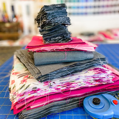 A stack of cut up squares of fabric 