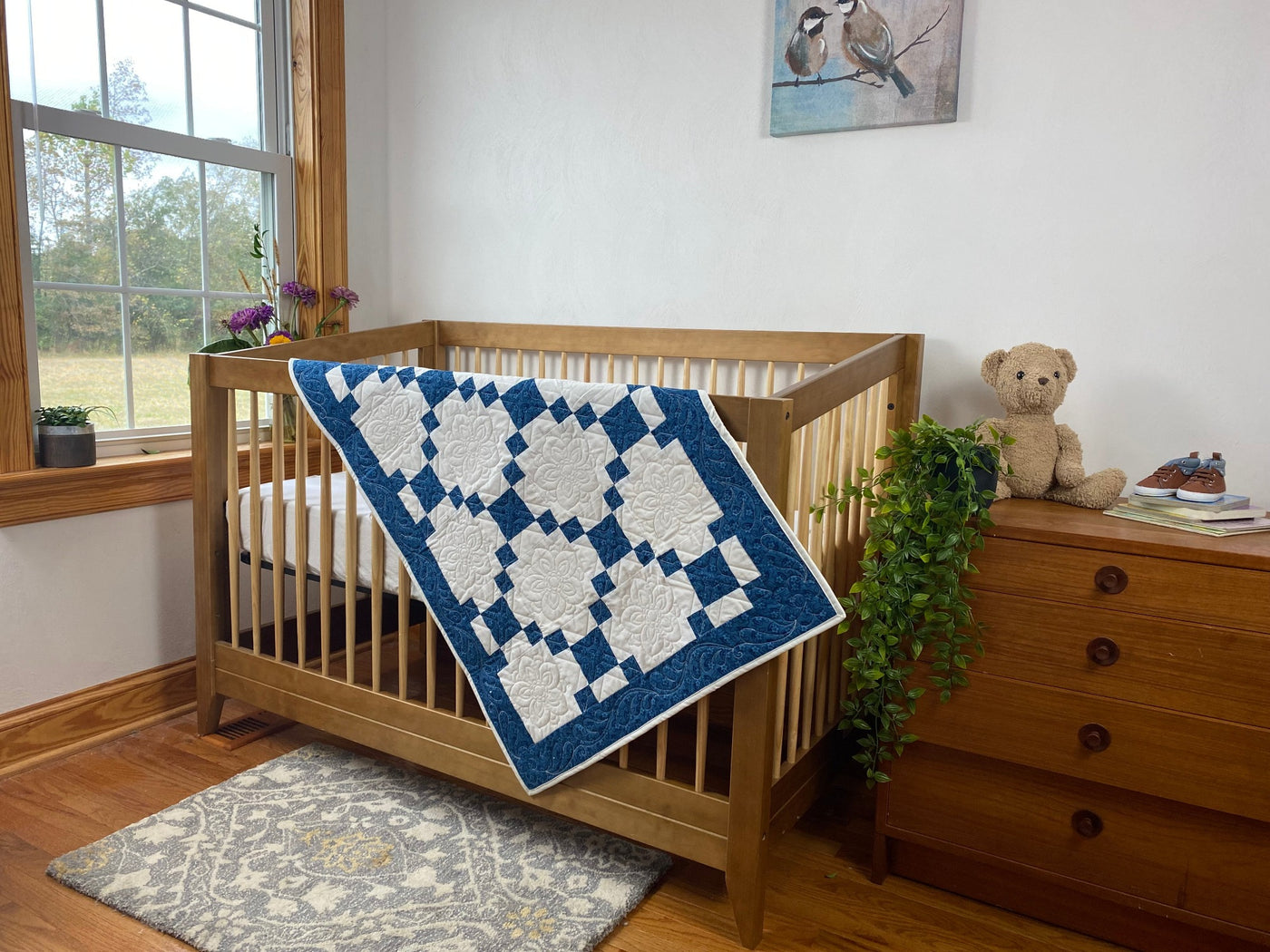  A handmade, heirloom, patchwork of indigo/blue nine patch with white background fabric, natural color backing, 100% cotton batting, Floral top quilting in the white centers, X's in the 9 patch squares, and feathers along the borders, machine top stitched binding, on this size quilt